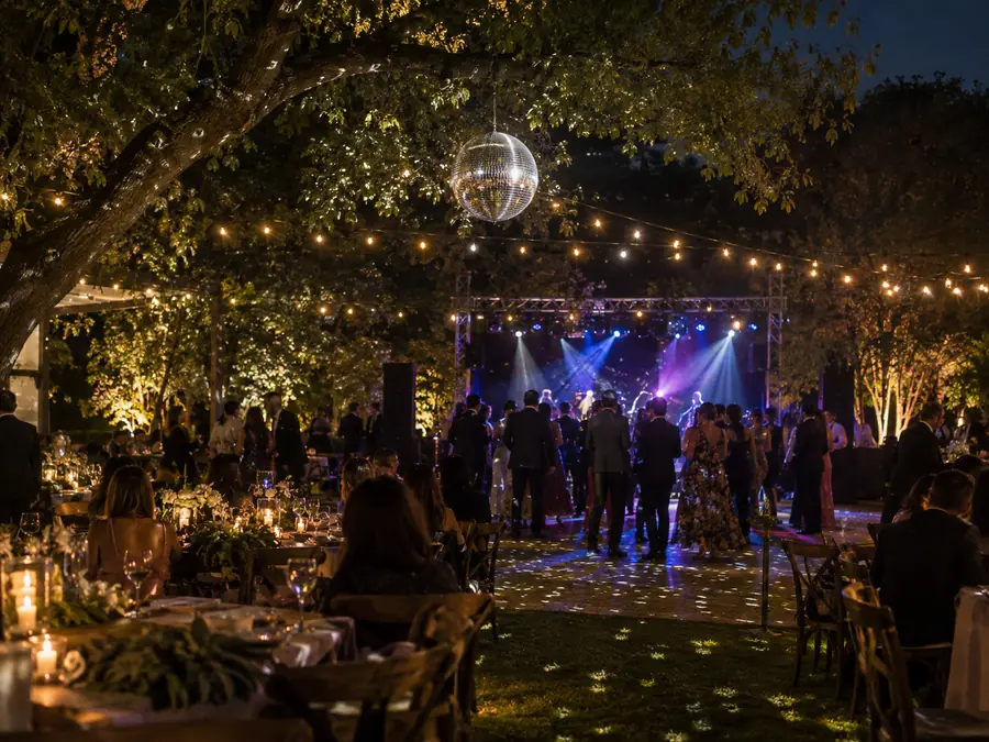 Bola disco colgada de un árbol en una boda en jardín
