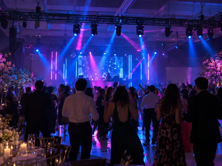 Salón de fiesta con luces LED azul y magenta en la pista